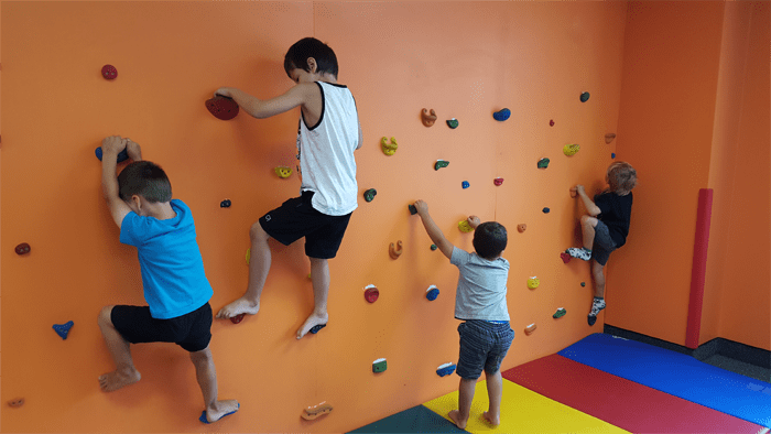 Activity centre. Gym activity центр. Boys on Climbing Wall in School physical Education class. Training Center for Kids advertising.